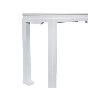 A close-up of the corner of the Wylder Console, a classic white rectangular table with straight legs, set against a plain white background.