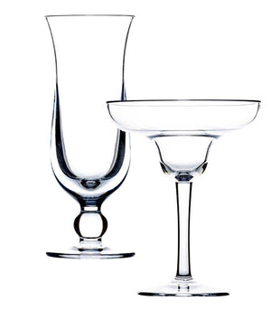 Two empty acrylic glassware pieces: a tall champagne flute on the left and a wide-rimmed margarita glass on the right, perfect for island-inspired cocktails. Both are part of the Bold Calypso Acrylic Collection, with their clear design inviting thoughts of sipping colder drinks on a tropical escape, set against a white background.