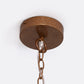 Close-up of the Alondra Chandelier's round, brown metal ceiling canopy with a chain and clear cord hanging down in an abstract shape.