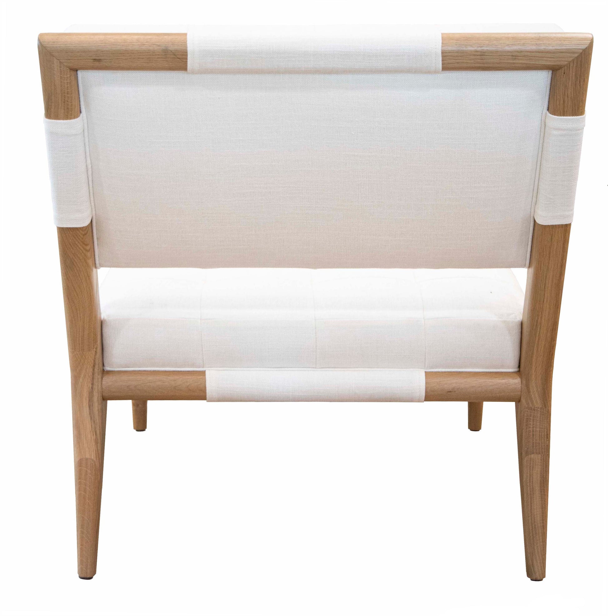 A light wood-framed Chatfield Armless Chair with white seat and back cushions, viewed from the back, exudes classic simplicity while incorporating a touch of modern flair.