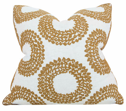 Square white Dashiki Cinnamon Pillow with a repeating pattern of overlapping gold circles, meticulously crafted from the finest materials for a luxurious touch. This custom-made pillow showcases impeccable attention to detail.