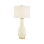 The Orson Balustrade Form Table Lamp features a cream ceramic rounded base, gold accents, and a white cylindrical shade, shown against a white background.