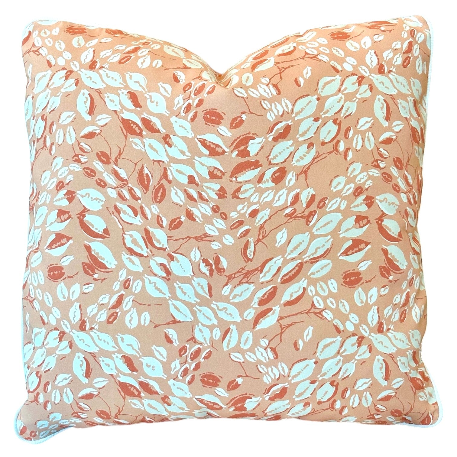 The Cowrie Shell Coral Outdoor Pillow features a peach background with a white and coral leaf design, expertly crafted for lasting comfort.