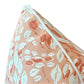 The Cowrie Shell Coral Outdoor Pillow features a peach and white seashell and leaf pattern with white piping. Crafted from premium materials, this custom-made pillow brings coastal charm to any setting.