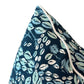 Close-up of the Cowrie Shell Navy Outdoor Pillow, custom-made with a blue and white botanical pattern and white piped edging, crafted from premium materials against a white background.