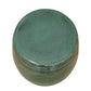 The Olive Green Cylinder Stool features a round, porcelain design with a smooth, glazed surface and matching top, seen from above.