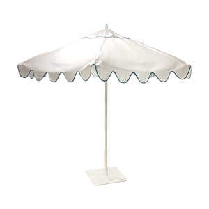 The Montecito Hex Umbrella is a white luxury outdoor umbrella featuring a scalloped edge, blue trim, and a sturdy square base—ideal for those seeking elegant shade.