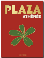 Cover of the book titled "Plaza Athenee" in gold and white text on a red background, with a green leaf graphic in the center. Showcasing Jean Imbert's touch of French hospitality, this elegant edition is published by Assouline.