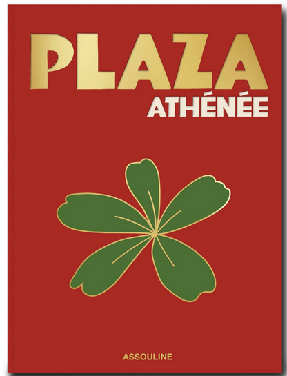 Cover of the book titled "Plaza Athenee" in gold and white text on a red background, with a green leaf graphic in the center. Showcasing Jean Imbert's touch of French hospitality, this elegant edition is published by Assouline.