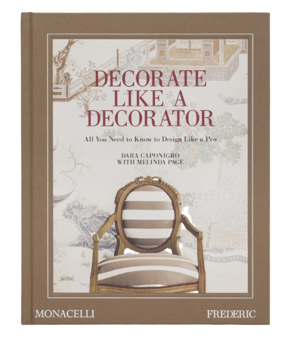 A hardcover book titled "Decorate Like a Decorator: All You Need to Know to Design Like a Pro" by Dara Caponigro and Melinda Page. The cover features a stylized chair and decorative patterns, promising decorating tricks to transform a room with decorator pro moves. Publisher: Monacelli, Frederic.
