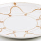 A round white ceramic plate featuring Themis Z Serenity Beige Collection's Serenity pattern, with a light brown wavy line and dot design around the rim.