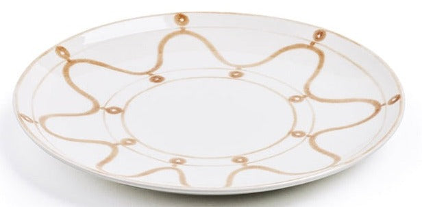 A round white ceramic plate featuring Themis Z Serenity Beige Collection's Serenity pattern, with a light brown wavy line and dot design around the rim.