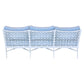The Haret Outdoor Sofa from our signature fretwork collection features a white metal frame with a geometric lattice backrest and three light blue cushions, shown here from the rear.