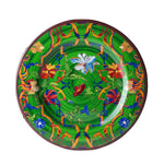 The Mario Luca Giusti Pancale Green Collection decorative ceramic plate displays a vibrant green backdrop and combines modern shapes with colorful floral and abstract patterns in shades of red, blue, yellow, and orange.