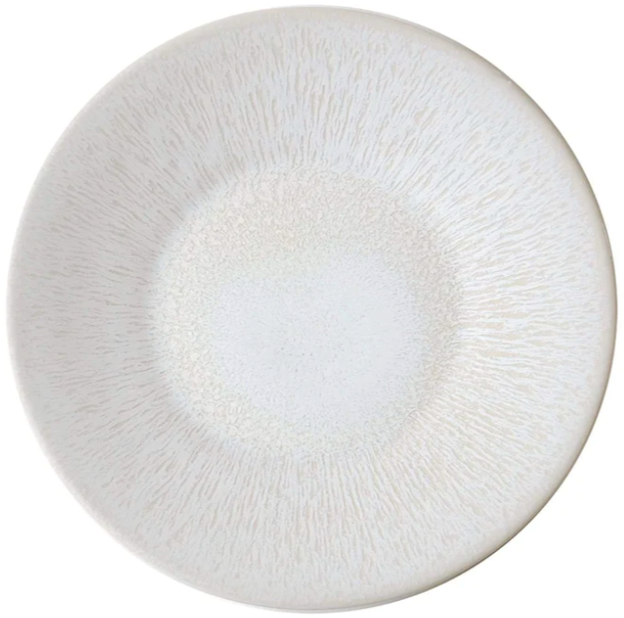 A round, off-white ceramic plate with a slightly textured pattern radiating from the center to the edges, exuding timeless elegance from the Jars Vuelta White Pearl Collection.