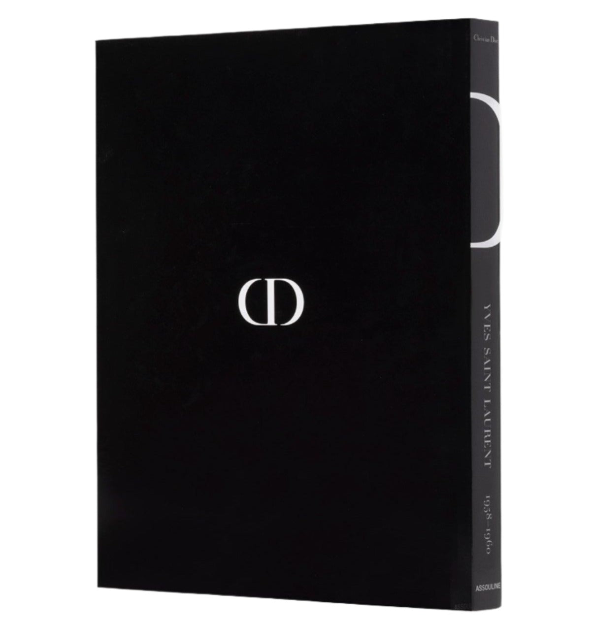 A black book with a white "CD" logo on the cover and "Dior: Yves Saint Laurent" written on the spine, showcasing haute couture.