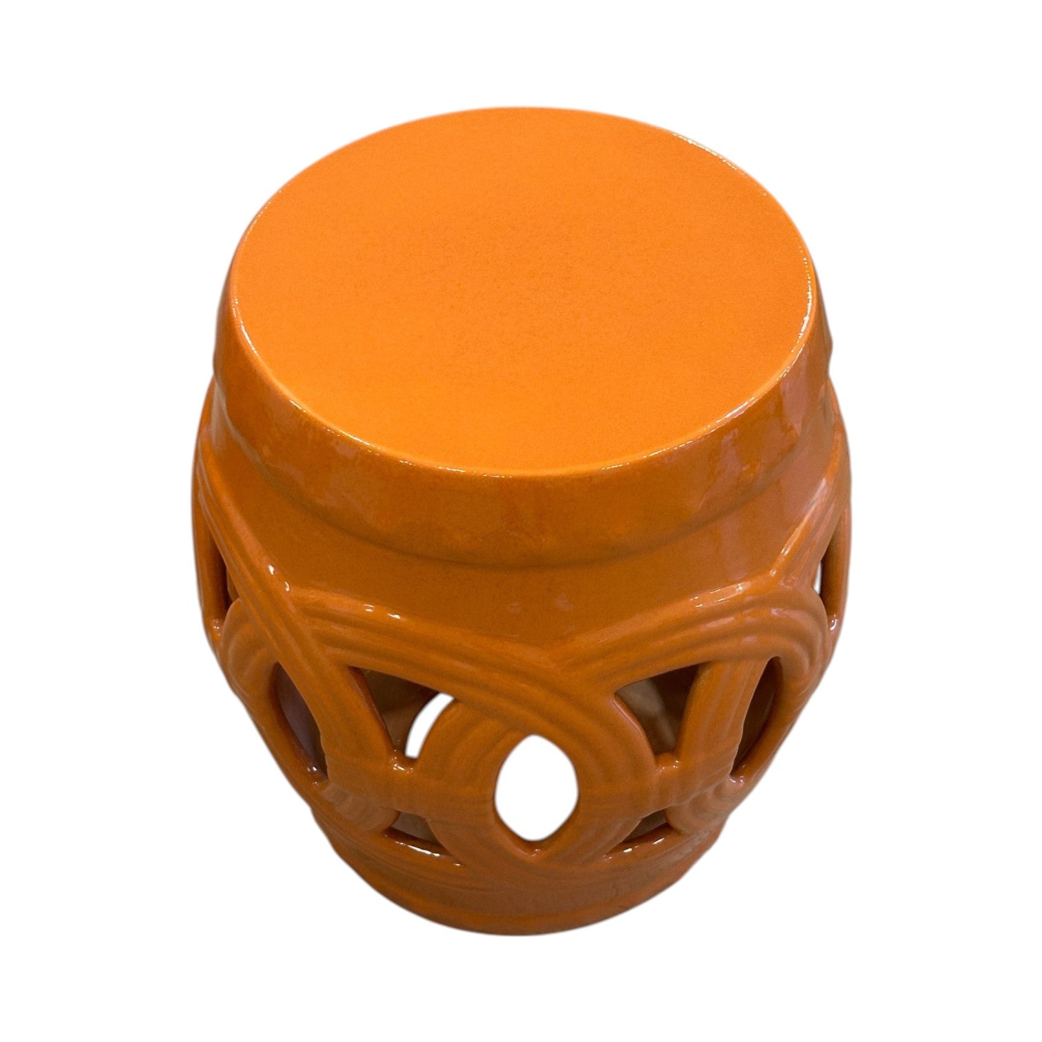 The Rusty Orange Fine Porcelain Circle Stool features a cylindrical shape, glossy finish, and decorative cut-out design around the sides.