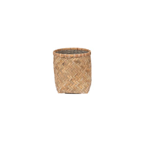 The Zayn Round Bamboo Planter is a small, cylindrical basket made from natural bamboo. Its organic design adds charm to any indoor or outdoor space and is shown here on a plain white background.