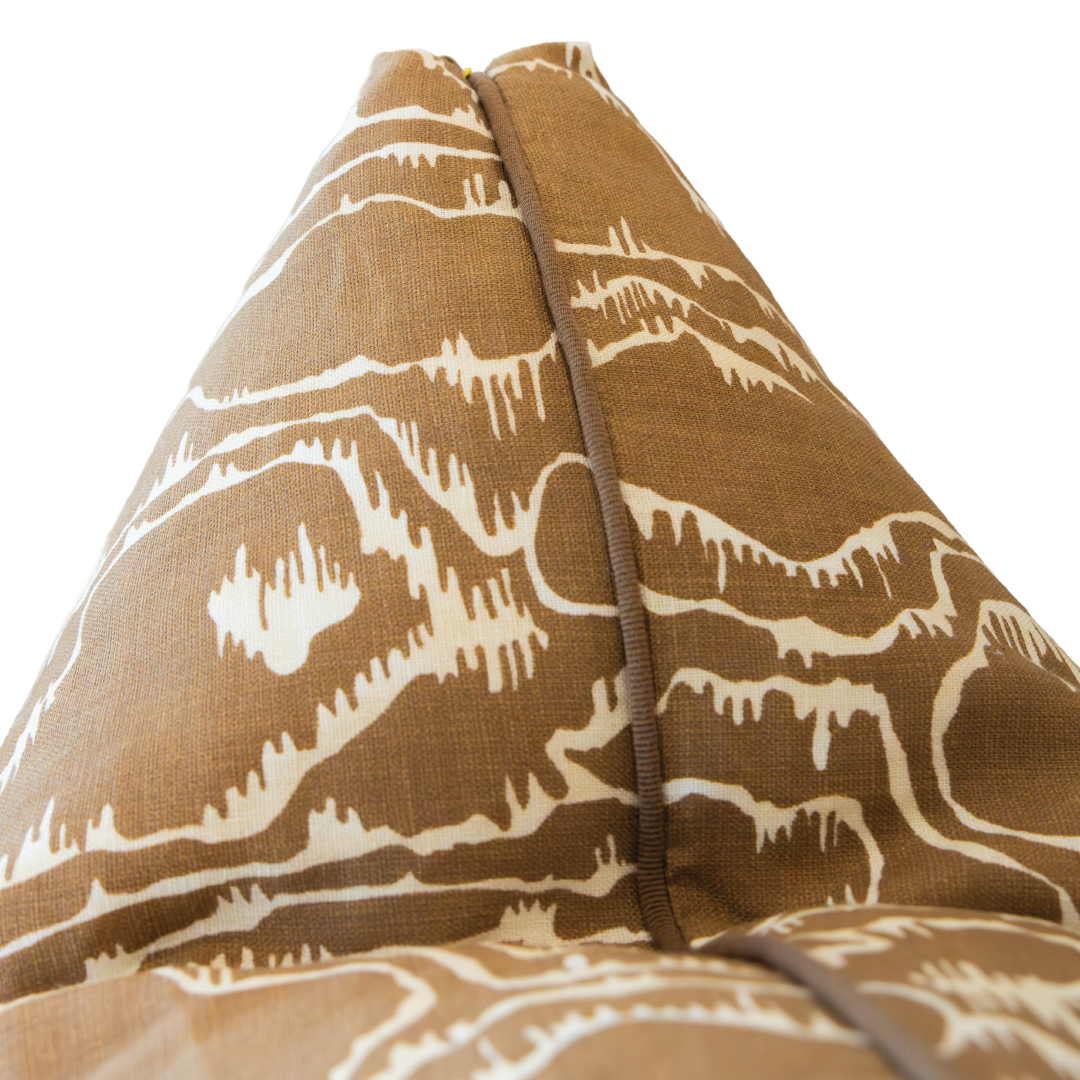 Close-up of the Tilda Acorn Pillow—a brown and white patterned cushion with a visible central seam, photographed against a white background. This custom pillow features a hidden zipper closure for a seamless finish.