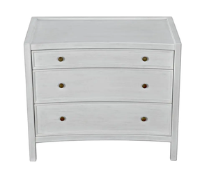 The Hampton Large Side Table is a white, three-drawer wooden chest with round metal knobs, a gently curved front, simple design, and classic white wash finish.