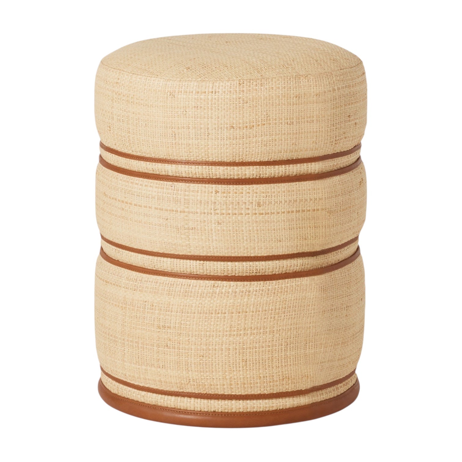 The Quinn Stool in Natural/Saddle is a round, beige woven raffia ottoman featuring two horizontal brown bands and a brown base, handcrafted and shown against a white background.