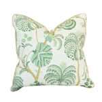 Introducing the Turquerie Green Pillow—a square decorative pillow featuring a white background adorned with green leafy botanical patterns, including palm and tropical plant designs. This custom-made pillow is crafted with a luxurious 100% down fill and finished with a hidden zipper closure for a seamless look.