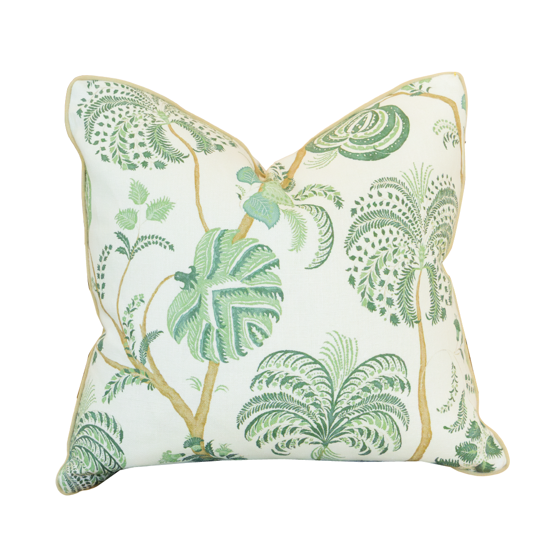 Introducing the Turquerie Green Pillow—a square decorative pillow featuring a white background adorned with green leafy botanical patterns, including palm and tropical plant designs. This custom-made pillow is crafted with a luxurious 100% down fill and finished with a hidden zipper closure for a seamless look.