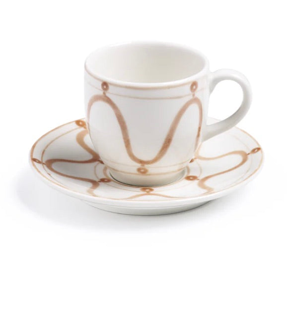 A white coffee cup with a handle and matching saucer, both featuring brown wavy line and dot patterns, is placed against a white background. This charming piece of Themis Z Serenity Beige Collection adds an elegant touch to any setting.