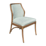 The Lantana Side Chair features a modern wooden frame, curved legs, and light blue custom fabric on the seat and backrest.