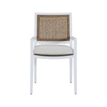 The Bermuda Arm Chair features a white frame, cane backrest, beige cushioned seat, and straight armrests, shown from the front against a plain background—ideal for outdoor dining.