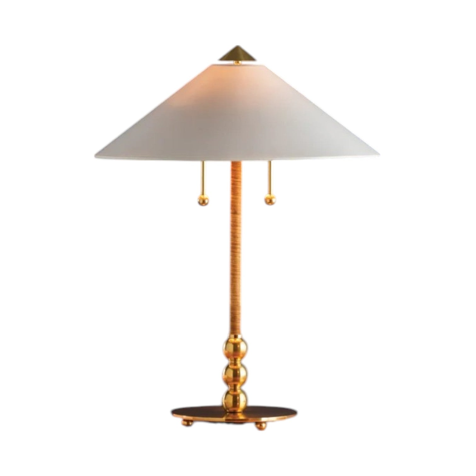 The Flare Table Lamp, Aged Brass, has a round base, decorative stem, and wide white conical shade with two pull chains—perfect for adding a chic touch to sophisticated décor against a white background.