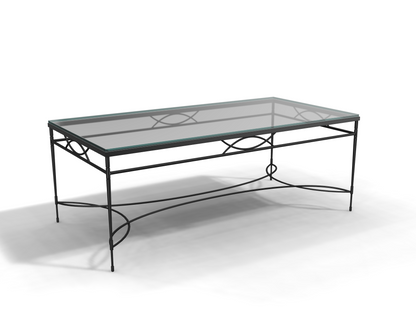 The Amalfi Glass Top Cocktail Table showcases a rectangular tempered glass surface and hand-forged steel frame with decorative curved supports, all set against a white background.