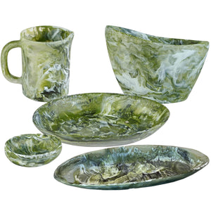 The Nashi Home Serveware Collection, Forest, features five green and white marbled resin pieces—a mug, large bowl, shallow bowl, and two plates—perfect as an elegant serving set for contemporary home decor.