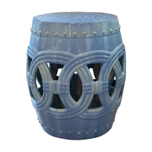 The Circle Garden Stool in Light Blue features openwork circular patterns and a glossy finish, inspired by rustic dragon kiln-fired stools. Shown against a white background.