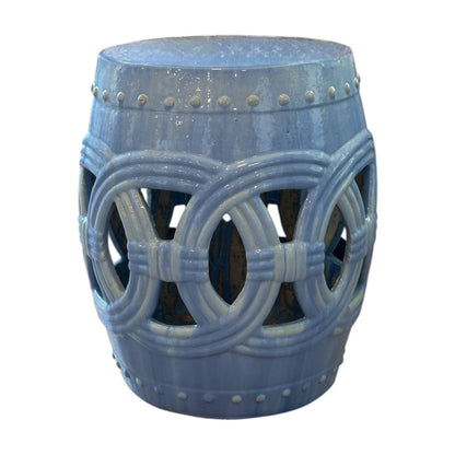 The Circle Garden Stool in Light Blue features openwork circular patterns and a glossy finish, inspired by rustic dragon kiln-fired stools. Shown against a white background.