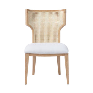 Wooden "Made Goods Carleen" wingback dining chair with white cushion and cane backrest, isolated on a white background.