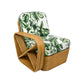 The Godfather Rattan 3 Piece Sofa features a curved wooden frame and white cushions upholstered in Calathea, showcasing a green tropical leaf pattern, set against a white background.