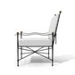 Side view of the Amalfi Adjustable Chain Lounge Chair, a modern powder coated steel lounge chair with a black metal frame, white seat and back cushions, and gold spherical accents on the corners, isolated on a white background.