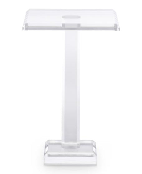 The Katie Acrylic Drink Table features a clear acrylic design with a rectangular top, central support, and square base, adding modern sophistication to any contemporary space. Photographed against a plain white background.
