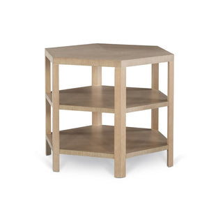 The Hex Side Table is a wooden, pentagon-shaped side table with three open shelves and a blonde cerused finish, inspired by modern hexagonal design.