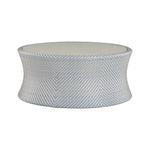 The Bari Round Coffee Table in Chambray features a drum shape, light blue and white chevron pattern, and a flat porcelain top—ideal for patios or gardens.