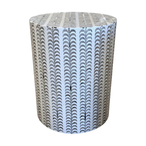 The Etched Stool is a cylindrical white garden stool featuring a pattern of black half-circle arches, ideal as a stylish decorative accent for both indoor and outdoor spaces.