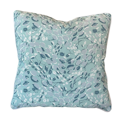 Cowrie Shell Aqua Outdoor Pillow: Square cushion featuring a light blue background with an abstract leaf and branch design in blue and white, made with high-quality materials for outdoor use.