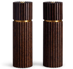 Two dark brown wooden cylindrical L'Objet Ionic Salt and Pepper Mills, crafted from European oak with vertically grooved patterns, feature gold bands near the top and a metal grinding mechanism.