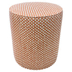 The Outdoor Drum Ottoman in Wicker Outwick Mandarin features cylindrical design and orange-white geometric upholstery, making it a vibrant addition to your outdoor space.