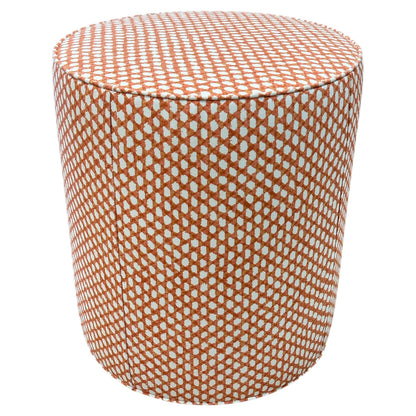 The Outdoor Drum Ottoman in Wicker Outwick Mandarin features cylindrical design and orange-white geometric upholstery, making it a vibrant addition to your outdoor space.