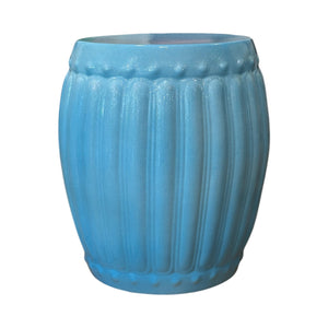 The Porcelain Ribbed Garden Stool in Lagoon Blue features vertical ridges and a glossy finish, shown against a white background.