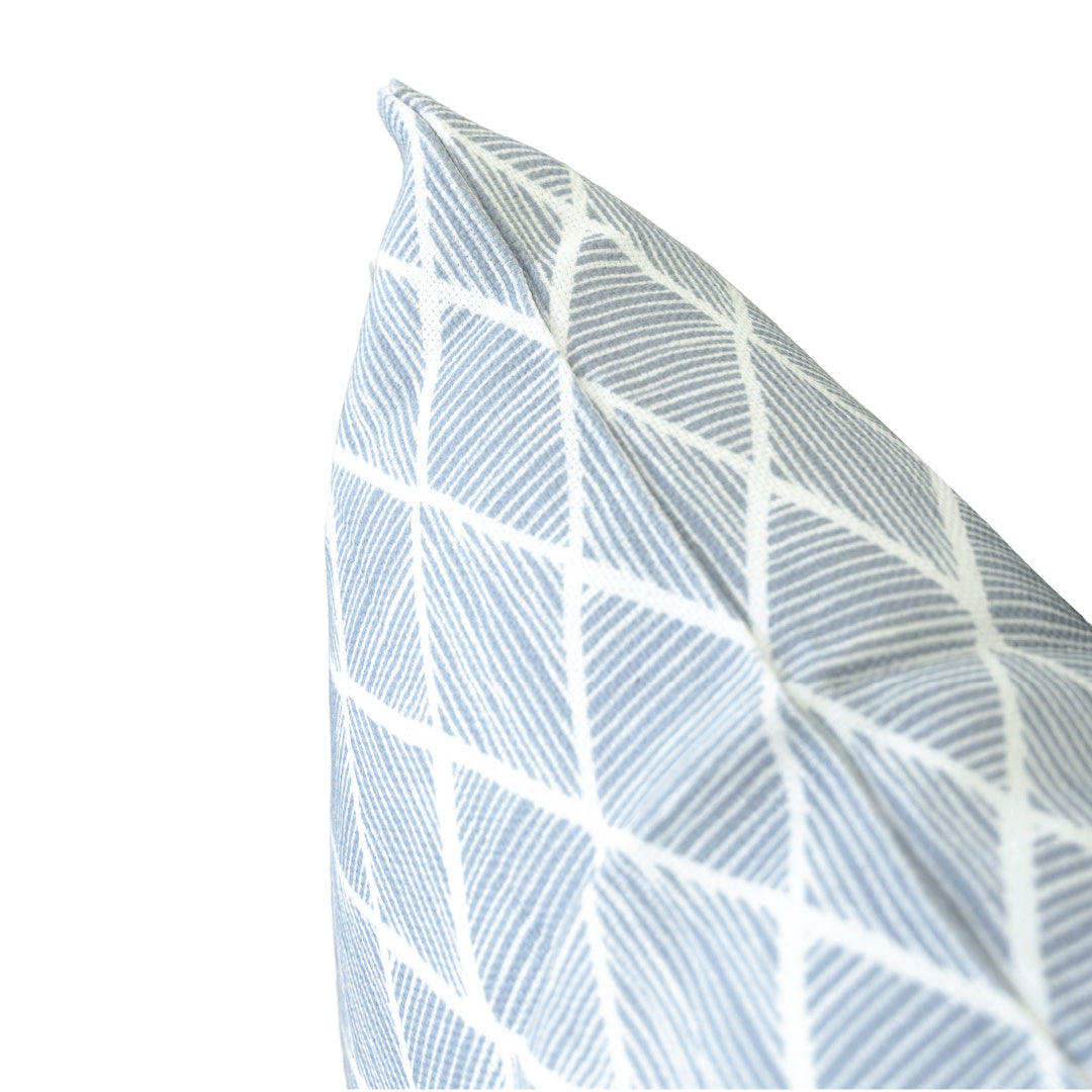 Close-up of the Raj Outdoor Lumbar Pillow, featuring a sun-resistant fabric with a light blue and white geometric pattern, set against a plain white background.