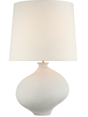 A Celia Large Right Table Lamp, Marion White with a round base and an oversized linen shade, perfect for coastal interiors.