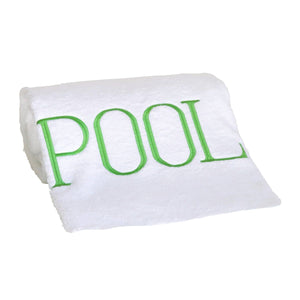 The Pool Towel, Kiwi is a white cotton terry towel with "POOL" embroidered in large green letters, making it the ideal poolside accessory.